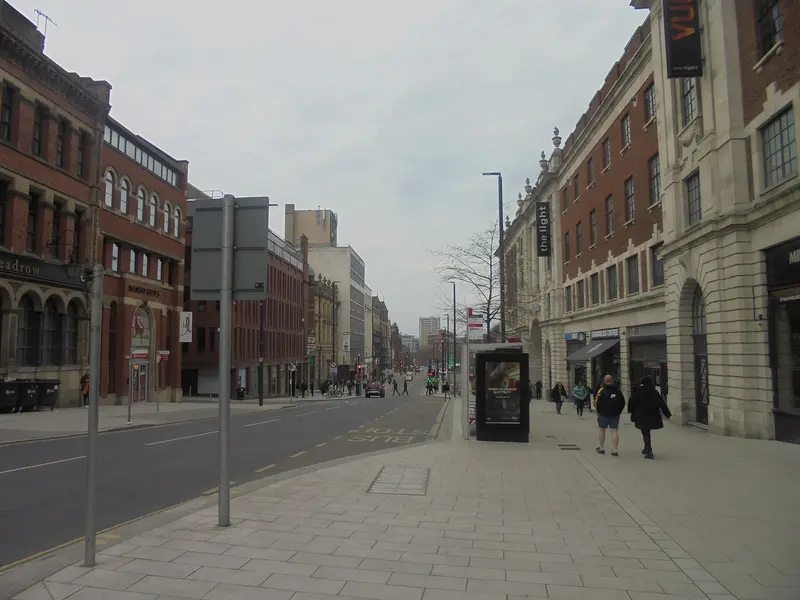 Wide pavements and red-brick and stone frontages along The Headrow