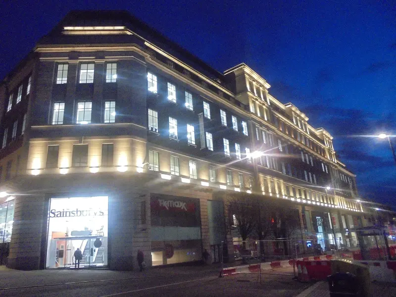 The former Lewis's department store building lit up at dusk